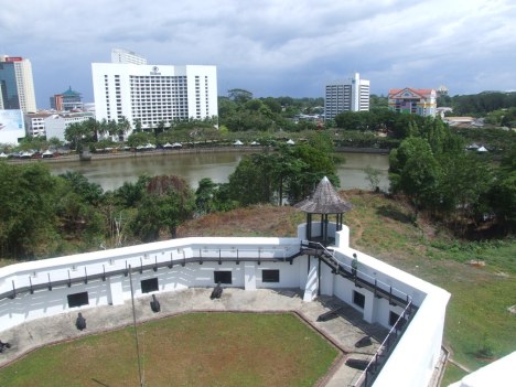 The curtain wall of the fort encompassing the courtyard, and the view of the city.